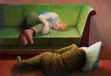 Young man lying on a green sofa